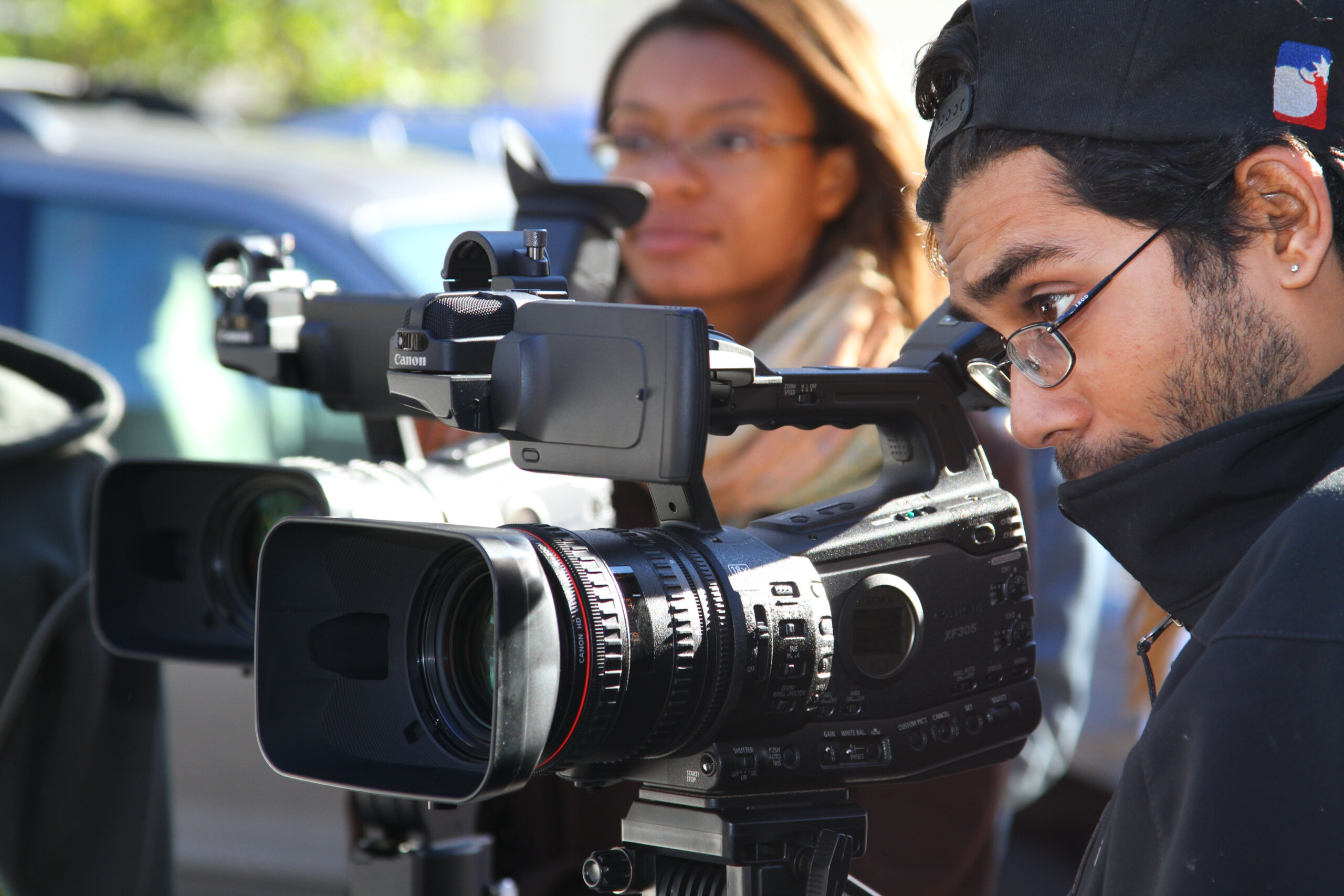 Students using a digital film camera. 